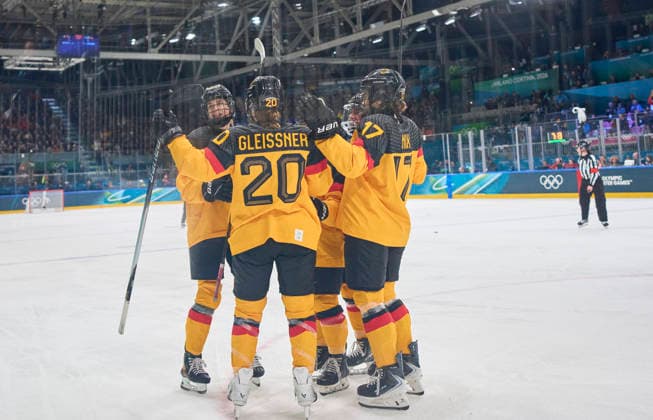 Emily Nix of Germany celebrates 1-1 goal, happy, laugh, celebration, with Laura Kluge of Germany Daria Gleissner of Germany at the preliminary women Ice hockey, Eishockey match Group B Germany - Italy of the Milano Cortina 2026 Winter Olympic Games, Olympische Spiele, Olympia, OS at Milano Rho Ice Hockey Arena on February 10, 2026 in Milan, Italy.