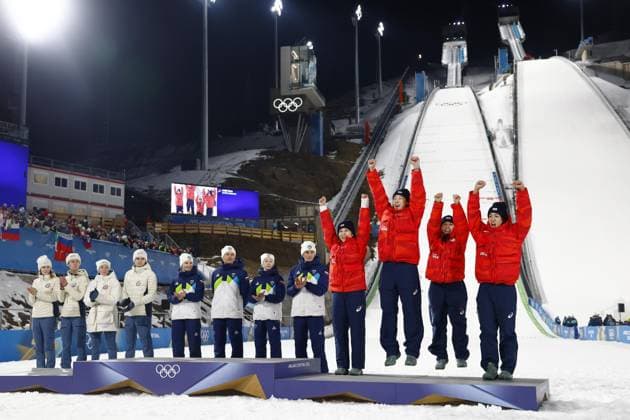 Milan Cortina Olympics: Ski jumping, Skispringen, Ski, nordisch Japanese ski jumpers (from L) Nozomi Maruyama, Ryoyu Kobayashi, Sara Takanashi and Ren Nikaido jump onto the podium after winning the mixed team bronze at the Milan Cortina Olympics on Feb. 10, 2026, at Predazzo Ski Jumping Stadium in Predazzo, Italy.  A14AA0005268271P