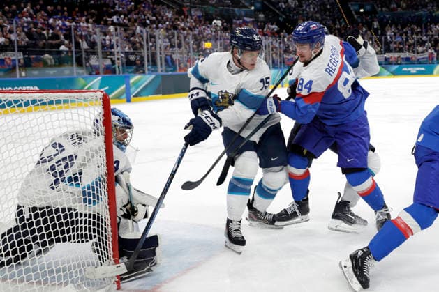 Milano Cortina 2026, Milan, Italy, 11.02, 2026, MiCo2026, MiCo, 2026, Olympics, Olympic, Winter Olympic, Olympic Winter games, Winterspiele,Spiele, Summer games Ice hockey, Eishockey Finland, Slovakia Juuse Saros of Finland, Anton Lundell of Finland and Pavol Regenda of Slovakia in action during Men™s Premilinary round Group B Ice Hockey match between Slovakia and Finland teams of Milano Cortina 2026 Olympic Winter Games in Milan, Italy, 11.02.2026. Photo: Roman Koksarov (RKF) Milan Italy Copyright: xRomanxKoksarovx _23A2697.JPG