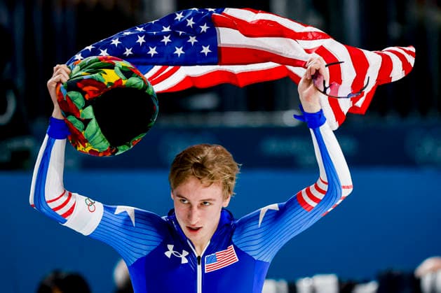 Milano Cortina 2026 Winter Olympics, Speed skating, Eisschnelllauf Day 5, Italy winner Jordan Stolz of United States of America celebrating and holding flag after competing on the Speed Skating Men 1000m on Day 5 of the Milano Cortina 2026 Winter Olympics at the Milano Speed Skating Stadium in Milan, Italy, February 11, 2026. Milan Italy  Copyright: xMatrixxImagesx xHenkxJanxDijksx