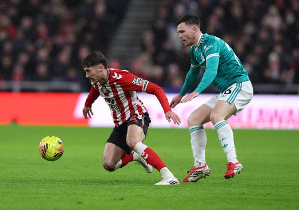 Sunderland, England, 11th February 2026. Trai Hume (L) of Sunderland in action with Andy Robertson of Liverpool during the Sunderland vs Liverpool Premier League match at the Stadium Of Light, Sunderland. Picture credit should read: Nigel Roddis Sportimage EDITORIAL USE ONLY. No use with unauthorised audio, video, data, fixture lists, club league logos or live services. Online in-match use limited to 120 images, no video emulation. No use in betting, games or single club league player publications. SPI_015_NR_SUND_LIVE SPI-4522-0017