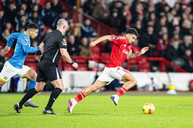 11th February 2026; The City Ground, Nottingham, England; Premier League Football, Nottingham Forest versus Wolverhampton Wanderers; Morgan Gibbs-White of Nottingham Forest runs with the ball past referee Tim Robinson  GodfreyxPitt Content restricted for UK based newspaper