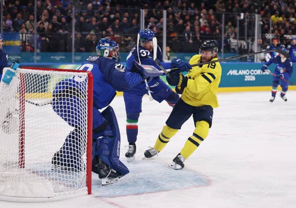 (260212) -- MILAN, Feb. 12, 2026 -- Adrian Kempe (R) of Sweden vies against Phil Pietroniro (C) of Italy during the Ice hockey, Eishockey men s preliminary round group B match between Italy and Sweden at the Milan-Cortina 2026 Olympic Winter games, Winterspiele,Spiele, Summer games in Milan, Italy, Feb. 11, 2026. ) (MICO2026)ITALY-MILAN-OLYMPIC WINTER GAMES-ICE HOCKEY-MEN-PRELIMINARY-ITA VS SWE WangxKaiyan 