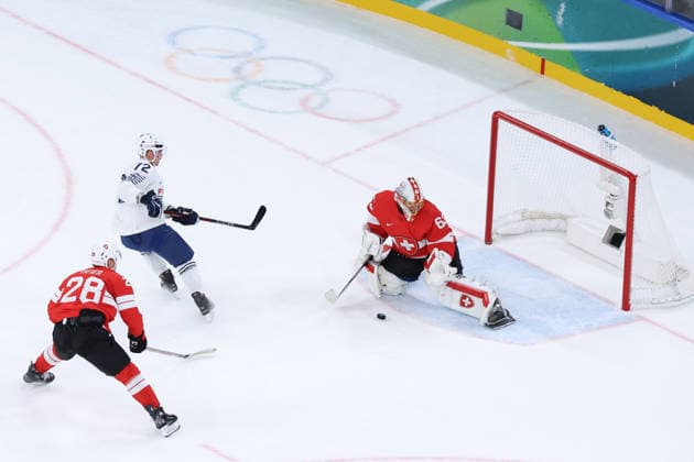 February 12, 2026, Milan, Lombardy, Italy: Goalie LEONARDO GENONI 63 of Team Switzerland makes a save on a shot by JORDANN PERRET 72 of Team France in the Men s Preliminary Round Group A game between Team Switzerland (SUI) and Team France (FRA) at the Milano Cortina 2026 Winter Olympic Games, Olympische Spiele, Olympia, OS Milan Italy - ZUMAc179 20260212_oly_c179_005 Copyright: xMickaelxChavetx