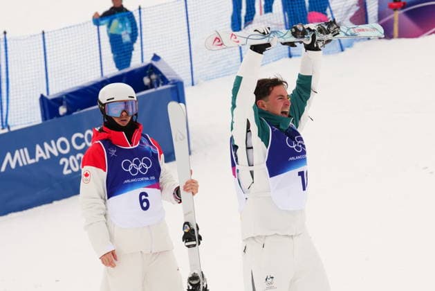 February 12, 2026, Livigno, Italy: Silver medal winner Canada s Mikael Kingsbury, left, looks on as Australia s Cooper Woods celebrates winning the men s moguls F2 final at the Milano Cortina 2026 Winter Olympic Games, Olympische Spiele, Olympia, OS in Livigno, Italy on Thursday, Feb. 12, 2026. Canada News - February 12, 2026  - ZUMAc35_ 20260212_zaf_c35_029 Copyright: xSeanxKilpatrickx