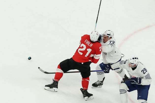 February 12, 2026, Milan, Lombardy, Italy: KEVIN FIALA 21 of Switzerland and JORDANN PERRET 72 of France fight for the puck in the Men s Preliminary Round Group A game between Team Switzerland (SUI) and Team France (FRA) at the Milano Cortina 2026 Winter Olympic Games, Olympische Spiele, Olympia, OS Milan Italy - ZUMAc179 20260212_oly_c179_033 Copyright: xMickaelxChavetx