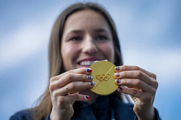 Olympic winner in snowboard parallel giant slalom Zuzana Maderova shows her gold medal during a meeting with the Governor of the Liberec Region Martin Puta, in Liberec, Czech Republic, on February 12, 2026. (CTKxPhoto RadekxPetrasek) CTKPhotoP2026021207326  CTKPhotoP2026021207326