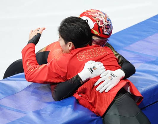 (260212) -- MILAN, Feb. 12, 2026 -- Sun Long (back) of China celebrates with teammate Liu Shaoang after the short track Speed skating, Eisschnelllauf men s 1000m final A at the Milan-Cortina 2026 Olympic Winter games, Winterspiele,Spiele, Summer games in Milan, Italy, Feb. 12, 2026. ) (MICO2026)ITALY-MILAN-OLYMPIC WINTER GAMES-SHORT TRACK SPEED SKATING-MEN S 1000M-FINALS LixMing 