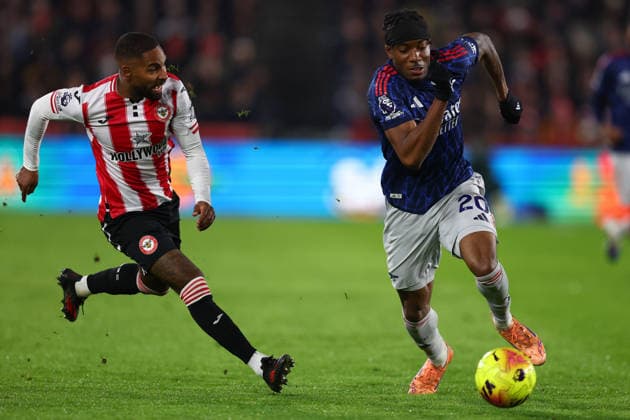 London, England, 12th February 2026. Rico Henry of Brentford and Noni Madueke of Arsenal challenge for the ball during the Brentford vs Arsenal Premier League match at Gtech Community Stadium, London. Picture credit should read: Paul Terry Sportimage EDITORIAL USE ONLY. No use with unauthorised audio, video, data, fixture lists, club league logos or live services. Online in-match use limited to 120 images, no video emulation. No use in betting, games or single club league player publications. SPI_057_PT_Brentford_Arsenal SPI-4523-0057