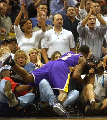 May 05, 2004; San Antonio, TX, USA; Lakers KOBE BRYANT trips and falls into photographers along the baseline at the SBC Center during game two of the NBA, Basketball Herren, USA Western Conference semifinals. The San Antonio Spurs beat the Los Angeles Lakers 95-85, and now lead the series 2-0. The Spurs jumped out to a 16-point first-quarter lead and fought off a late Lakers rally on the way to a 95-85 win in Game 2. Parker scored 30 points on 13-for-23 shooting for San Antonio. San Antonio TX USA Copyright: xBillyxCalzadax