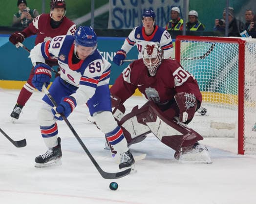 February 12, 2026, Milan, Lombardy, Italy: Jake Guentzel 59 of Team United States against Elvis Merzlikins 30 of Team Latvia in men s Ice hockey, Eishockey group C play during the Milano Cortina 2026 Olympic Winter games, Winterspiele,Spiele, Summer games at Milano Santagiulia Ice Hockey Arena Olympics 2026: Milano Cortina: Ice Hockey Men - Group C - LAT-USA  - ZUMAm117 20260212_oly_m117_027 Copyright: xDavidxMcIntyrex