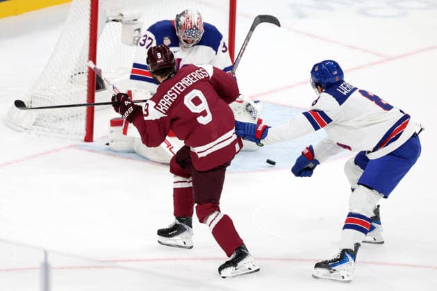 Milano Cortina 2026, Milan, Italy, 12.02, 2026, MiCo2026, MiCo, 2026, Olympics, Olympic, Winter Olympic, Olympic Winter games, Winterspiele,Spiele, Summer games Ice hockey, Eishockey Latvia, USA, United States Connor Hellebuyck, Zach Werenski of United States and Renars Krastenbergs of Latvia in action during men™s Premilinary round Group C Ice Hockey match between Latvia and USA teams of Milano Cortina 2026 Olympic Winter Games in Milan, Italy, 12.02.2026. Photo: Roman Koksarov (RKF) Milan Italy Copyright: xRomanxKoksarovx 0B4A2409.JPG