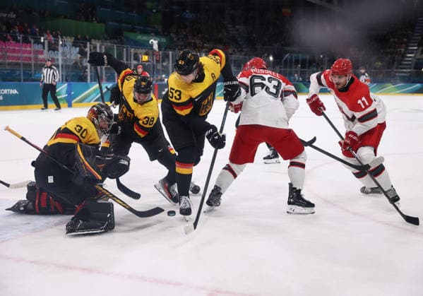 (260213) -- MILAN, Feb. 13, 2026 -- Philip Grubauer (1st L), goalkeeper of Germany, saves during the Ice hockey, Eishockey men s preliminary round group C match between Denmark and Germany at the Milan-Cortina 2026 Olympic Winter games, Winterspiele,Spiele, Summer games in Milan, Italy, Feb. 12, 2026. ) (MICO2026)ITALY-MILAN-OLYMPIC WINTER GAMES-ICE HOCKEY-MEN-PRELIMINARY-DEN VS GER WangxKaiyan 