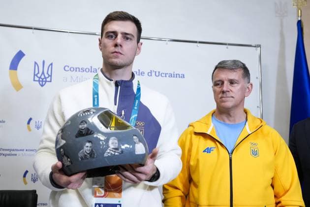 Milan Cortina Olympics: Disqualified Ukrainian athlete Ukrainian skeleton racer Vladyslav Heraskevych (L) meets the press in Milan on Feb. 12, 2026, after he was disqualified from the Milan Cortina Olympics for refusing to give up his plan to race in a helmet commemorating athletes killed since Russia s invasion.  A14AA0005277713P