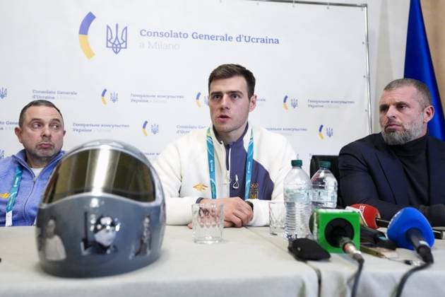 Milan Cortina Olympics: Disqualified Ukrainian athlete Ukrainian skeleton racer Vladyslav Heraskevych (C) meets the press in Milan on Feb. 12, 2026, after he was disqualified from the Milan Cortina Olympics for refusing to give up his plan to race in a helmet commemorating athletes killed since Russia s invasion.  A14AA0005277715P