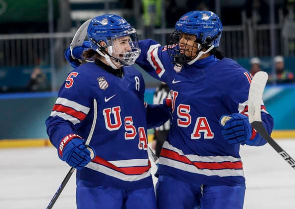 United States Megan Keller (5) celebrates scoring a goal with United States Laila Edwards (10) during the Women s Playoff Quarterfinal game between Italy and the USA at the Milano Rho Ice hockey, Eishockey Arena in Milan, Italy, on Friday, February 13, 2026.  OLY202602138609 AARONxJOSEFCZYK
