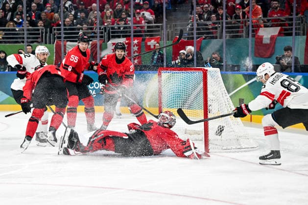 MILAN, ITALY - FEBRUARY 13: goalkeeper Logan Thompson of Canada makes a save against Sven Andrighetto of Switzerland R) during the Men™s Prelim Round match between Canada and Switzerland on day seven of the Milano Cortina 2026 Winter Olympic Games, Olympische Spiele, Olympia, OS at Milano Santagiulia IHO Arena on February 13, 2026 in Milan, Italy. Milan Milano Santagiulia IHO Arena Italy *** MILAN, ITALY FEBRUARY 13 goalkeeper Logan Thompson of Canada makes a save against Sven Andrighetto of Switzerland R during the Men™s Prelim Round match between Canada and Switzerland on day seven of the Milano Cortina 2026 Winter Olympic games at Milano Santagiulia IHO Arena on February 13, 2026 in Milan, Italy Milan Milano Santagiulia IHO Arena Italy Copyright: xJustPictures.ch AndreaxBrancax jp-en-EuSpIm-AB-AAB_509513022026
