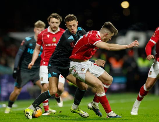 Wrexham, Wales, 13th February 2026. Kasey McAteer of Ipswich Town tussles with George Thomason of Wrexham during the Wrexham vs Ipswich Town FA Cup fourth round match at the SToK Car Ras, Wrexham. Picture credit should read: Cody Froggatt Sportimage EDITORIAL USE ONLY. No use with unauthorised audio, video, data, fixture lists, club league logos or live services. Online in-match use limited to 120 images, no video emulation. No use in betting, games or single club league player publications. SPI_035_CF_WREXHAM_V_IPSWICH SPI-4531-0032
