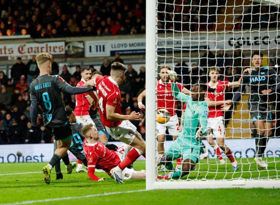 Wrexham, Wales, 13th February 2026. Arthur Okonkwo of Wrexham saves a shot from Chuba Akpom of Ipswich Town during the Wrexham vs Ipswich Town FA Cup fourth round match at the SToK Car Ras, Wrexham. Picture credit should read: Cody Froggatt Sportimage EDITORIAL USE ONLY. No use with unauthorised audio, video, data, fixture lists, club league logos or live services. Online in-match use limited to 120 images, no video emulation. No use in betting, games or single club league player publications. SPI_033_CF_WREXHAM_V_IPSWICH SPI-4531-0033