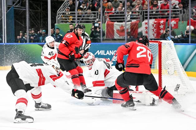 MILAN, ITALY - FEBRUARY 13: Akira Schmid of Switzerland makes a save on Nathan MacKinnon of Canada during the Men™s Prelim Round match between Canada and Switzerland on day seven of the Milano Cortina 2026 Winter Olympic Games, Olympische Spiele, Olympia, OS at Milano Santagiulia IHO Arena on February 13, 2026 in Milan, Italy. Milan Milano Santagiulia IHO Arena Italy *** MILAN, ITALY FEBRUARY 13 Akira Schmid of Switzerland makes a save on Nathan MacKinnon of Canada during the Men™s Prelim Round match between Canada and Switzerland on day seven of the Milano Cortina 2026 Winter Olympic games at Milano Santagiulia IHO Arena on February 13, 2026 in Milan, Italy Milan Milano Santagiulia IHO Arena Italy Copyright: xJustPictures.ch AndreaxBrancax jp-en-EuSpIm-AB-AAB_640313022026