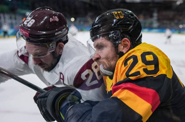 (260214) -- MILAN, Feb. 14, 2026 -- Zegmus Girgensons (L) of Latvia and Leon Draisaitl of Germany battle for the puck during the Ice hockey, Eishockey men s preliminary round group C match between Germany and Latvia of the Milan-Cortina 2026 Olympic Winter games, Winterspiele,Spiele, Summer games in Milan, Italy, Feb. 14, 2026. ) (MICO2026)ITALY-MILAN-OLYMPIC WINTER GAMES-ICE HOCKEY-MEN-PRELIMINARY-GER VS LAT SunxFei 