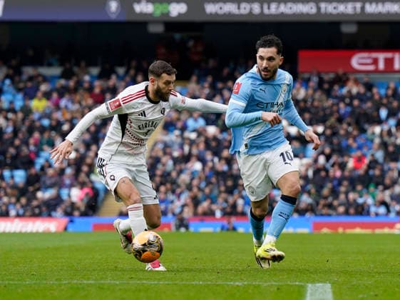 Manchester, England, 14th February 2026. Jorge Grant of Salford City and Rayan Cherki of Manchester City during the Manchester City vs Salford City FA Cup fourth round match at the Etihad Stadium, Manchester. Picture credit should read: Andrew Yates Sportimage EDITORIAL USE ONLY. No use with unauthorised audio, video, data, fixture lists, club league logos or live services. Online in-match use limited to 120 images, no video emulation. No use in betting, games or single club league player publications. SPI_023_AY_Man_City_Salford SPI-4533-0024