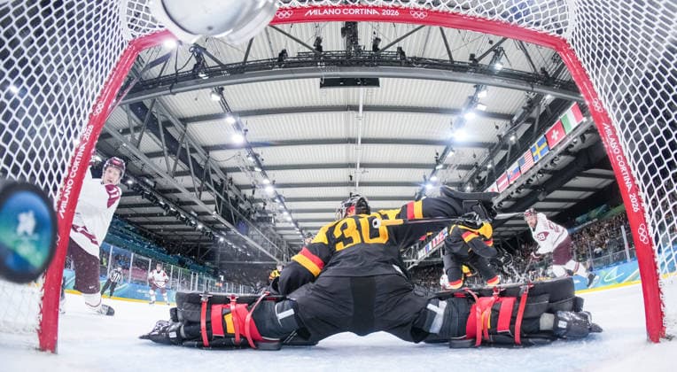 (260214) -- MILAN, Feb. 14, 2026 -- Dans Locmelis (1st L) of Latvia scores during the Ice hockey, Eishockey men s preliminary round group C match between Germany and Latvia of the Milan-Cortina 2026 Olympic Winter games, Winterspiele,Spiele, Summer games in Milan, Italy, Feb. 14, 2026. ( Pool via Xinhua) (MICO2026)ITALY-MILAN-OLYMPIC WINTER GAMES-ICE HOCKEY-MEN-PRELIMINARY-GER VS LAT SunxFei 