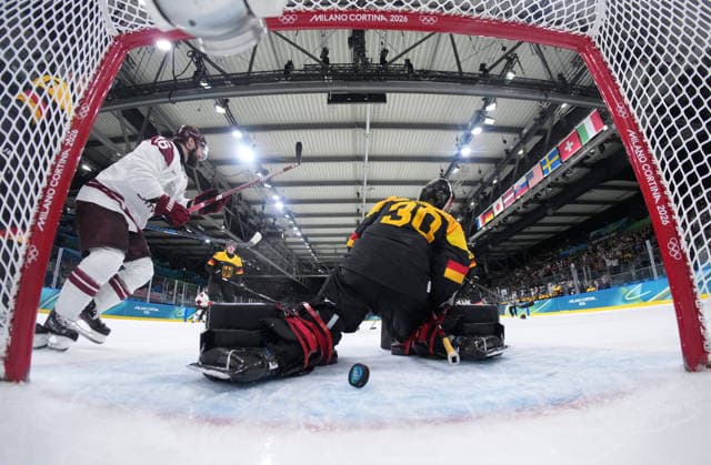 (260214) -- MILAN, Feb. 14, 2026 -- Philipp Grubauer (front), goalkeeper of Germany fails to make a save during the Ice hockey, Eishockey men s preliminary round group C match between Germany and Latvia of the Milan-Cortina 2026 Olympic Winter games, Winterspiele,Spiele, Summer games in Milan, Italy, Feb. 14, 2026. ( Pool via Xinhua) (MICO2026)ITALY-MILAN-OLYMPIC WINTER GAMES-ICE HOCKEY-MEN-PRELIMINARY-GER VS LAT SunxFei 