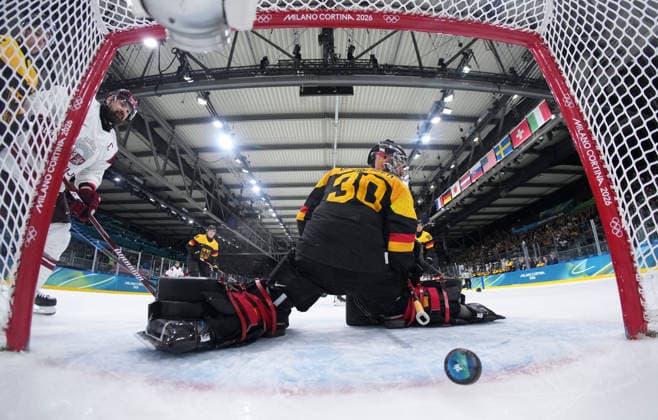 (260214) -- MILAN, Feb. 14, 2026 -- Philipp Grubauer (front), goalkeeper of Germany fails to make a save during the Ice hockey, Eishockey men s preliminary round group C match between Germany and Latvia of the Milan-Cortina 2026 Olympic Winter games, Winterspiele,Spiele, Summer games in Milan, Italy, Feb. 14, 2026. ( Pool via Xinhua) (MICO2026)ITALY-MILAN-OLYMPIC WINTER GAMES-ICE HOCKEY-MEN-PRELIMINARY-GER VS LAT SunxFei 