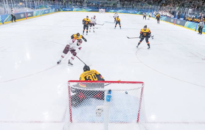 (260214) -- MILAN, Feb. 14, 2026 -- Eduards Tralmaks (1st L) of Latvia shoots to score during the Ice hockey, Eishockey men s preliminary round group C match between Germany and Latvia of the Milan-Cortina 2026 Olympic Winter games, Winterspiele,Spiele, Summer games in Milan, Italy, Feb. 14, 2026. ) (MICO2026)ITALY-MILAN-OLYMPIC WINTER GAMES-ICE HOCKEY-MEN-PRELIMINARY-GER VS LAT SunxFei 