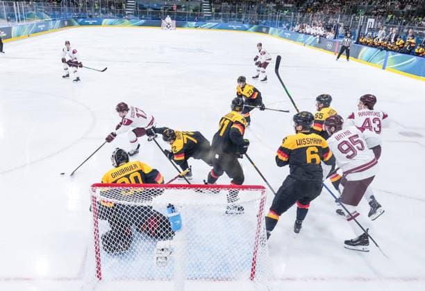 (260214) -- MILAN, Feb. 14, 2026 -- Martins Dzierkals (2nd L) of Latvia shoots during the Ice hockey, Eishockey men s preliminary round group C match between Germany and Latvia of the Milan-Cortina 2026 Olympic Winter games, Winterspiele,Spiele, Summer games in Milan, Italy, Feb. 14, 2026. ) (MICO2026)ITALY-MILAN-OLYMPIC WINTER GAMES-ICE HOCKEY-MEN-PRELIMINARY-GER VS LAT SunxFei 