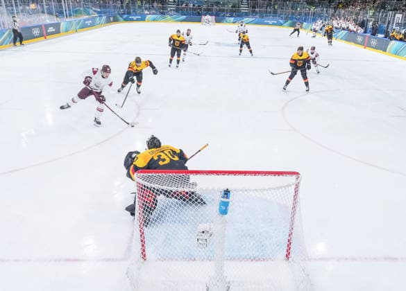 (260214) -- MILAN, Feb. 14, 2026 -- Eduards Tralmaks (1st L) of Latvia shoots to score during the Ice hockey, Eishockey men s preliminary round group C match between Germany and Latvia of the Milan-Cortina 2026 Olympic Winter games, Winterspiele,Spiele, Summer games in Milan, Italy, Feb. 14, 2026. ) (MICO2026)ITALY-MILAN-OLYMPIC WINTER GAMES-ICE HOCKEY-MEN-PRELIMINARY-GER VS LAT SunxFei 