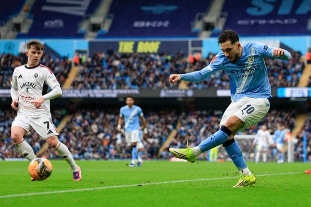 Manchester City v Salford City, FA Cup Rayan Cherki (10) of Manchester City crosses the ball watched by Ben Woodburn (7) of Salford City during the FA Cup match between Manchester City and Salford City at the Etihad Stadium, Manchester, UK on 14 February 2026. Manchester Etihad Stadium Manchester UK Editorial use only DataCo restrictions apply See www.football-dataco.com , Copyright: xConorxMolloyx PSI-23752-0031