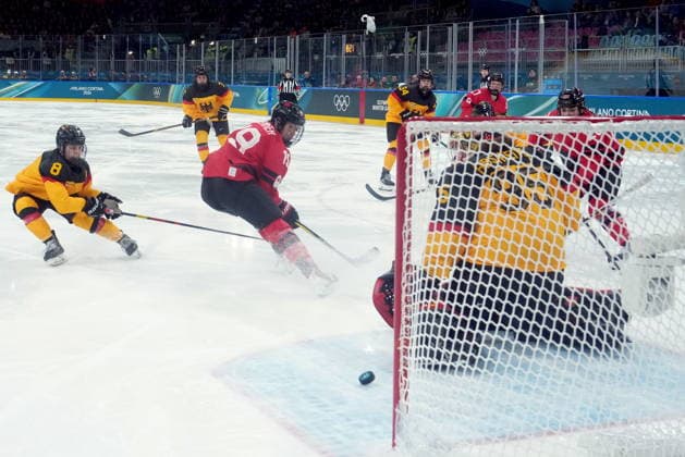 February 14, 2026, Milan, ITALY: Canada s Brianne Jenner (19) scores on Germany goalie Sandra Abstreiter during the first period of a women s hockey quarterfinal game at the 2026 Winter Olympics, in Milan, Saturday, Feb. 14, 2026. Canada News - February 14, 2026  - ZUMAc35_ 20260214_zaf_c35_010 Copyright: xDarrylxDyckx