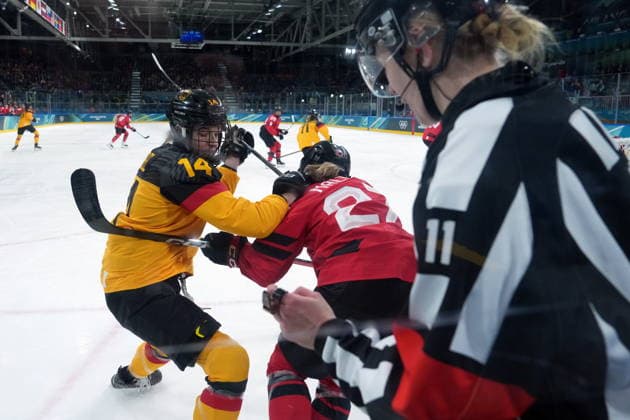 February 14, 2026, Milan, ITALY: Germany s Carina Strobel (14) and Canada s Emma Maltais (27) vie for control of the puck during the first period of a women s hockey quarterfinal game at the 2026 Winter Olympics, in Milan, Saturday, Feb. 14, 2026. Canada News - February 14, 2026  - ZUMAc35_ 20260214_zaf_c35_014 Copyright: xDarrylxDyckx