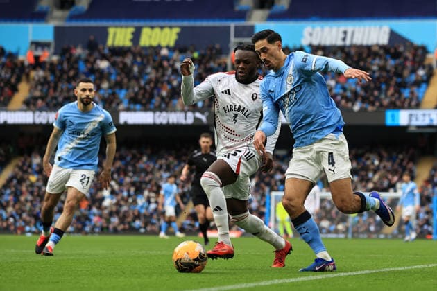 14th February 2026; Etihad Stadium, Manchester, Lancashire, England; FA Cup Football, Manchester City versus Salford City ; Tijjani Reijnders of Manchester City takes on Rosaire Longelo of Salford City  DavidxBlunsden Content restricted for UK based newspaper