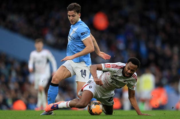 14th February 2026; Etihad Stadium, Manchester, Lancashire, England; FA Cup Football, Manchester City versus Salford City ; Nico Gonzales of Manchester City brings down Zach Awe of Salford City  DavidxBlunsden Content restricted for UK based newspaper