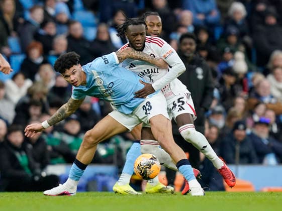 Manchester, England, 14th February 2026. Nico O™Reilly of Manchester City and Rosaire Longelo of Salford City during the Manchester City vs Salford City FA Cup fourth round match at the Etihad Stadium, Manchester. Picture credit should read: Andrew Yates Sportimage EDITORIAL USE ONLY. No use with unauthorised audio, video, data, fixture lists, club league logos or live services. Online in-match use limited to 120 images, no video emulation. No use in betting, games or single club league player publications. SPI_052_AY_Man_City_Salford SPI-4533-0054