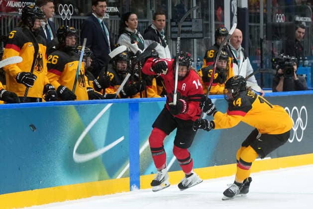 February 14, 2026, Milan, ITALY: Canada s Renata Fast (14) and Germany s Carina Strobel, right, vie for control of the puck during the first period of a women s hockey quarterfinal game at the 2026 Winter Olympics, in Milan, Saturday, Feb. 14, 2026. Canada News - February 14, 2026  - ZUMAc35_ 20260214_zaf_c35_027 Copyright: xDarrylxDyckx