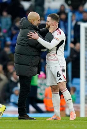 Manchester, England, 14th February 2026. Pep Guardiola coach of Manchester City consoled Oliver Turton of Salford City during the Manchester City vs Salford City FA Cup fourth round match at the Etihad Stadium, Manchester. Picture credit should read: Andrew Yates Sportimage EDITORIAL USE ONLY. No use with unauthorised audio, video, data, fixture lists, club league logos or live services. Online in-match use limited to 120 images, no video emulation. No use in betting, games or single club league player publications. SPI_056_AY_Man_City_Salford SPI-4533-0059