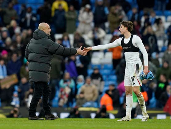 Manchester, England, 14th February 2026. Pep Guardiola coach of Manchester City consoles Joss Austerfield of Salford City during the Manchester City vs Salford City FA Cup fourth round match at the Etihad Stadium, Manchester. Picture credit should read: Andrew Yates Sportimage EDITORIAL USE ONLY. No use with unauthorised audio, video, data, fixture lists, club league logos or live services. Online in-match use limited to 120 images, no video emulation. No use in betting, games or single club league player publications. SPI_057_AY_Man_City_Salford SPI-4533-0060