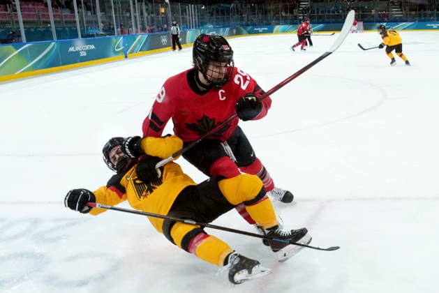 February 14, 2026, Milan, ITALY: Canada s Marie-Philip Poulin (29) checks Germany s Ronja Hark (8) during the second period of a women s hockey quarterfinal game at the 2026 Winter Olympics, in Milan, Saturday, Feb. 14, 2026. Canada News - February 14, 2026  - ZUMAc35_ 20260214_zaf_c35_037 Copyright: xDarrylxDyckx