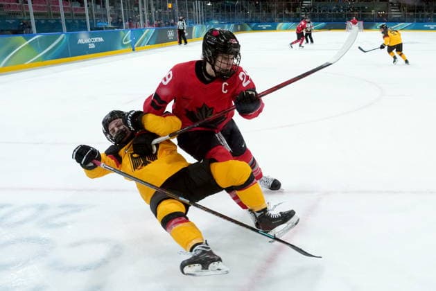 February 14, 2026, Milan, ITALY: Canada s Marie-Philip Poulin (29) checks Germany s Ronja Hark (8) during the second period of a women s hockey quarterfinal game at the 2026 Winter Olympics, in Milan, Saturday, Feb. 14, 2026. Canada News - February 14, 2026  - ZUMAc35_ 20260214_zaf_c35_038 Copyright: xDarrylxDyckx