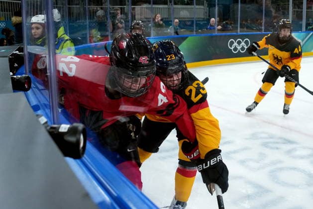 February 14, 2026, Milan, ITALY: Germany s Lilli Welcke (23) checks Canada s Claire Thompson (42) during the second period of a women s hockey quarterfinal game at the 2026 Winter Olympics, in Milan, Saturday, Feb. 14, 2026. Canada News - February 14, 2026  - ZUMAc35_ 20260214_zaf_c35_061 Copyright: xDarrylxDyckx