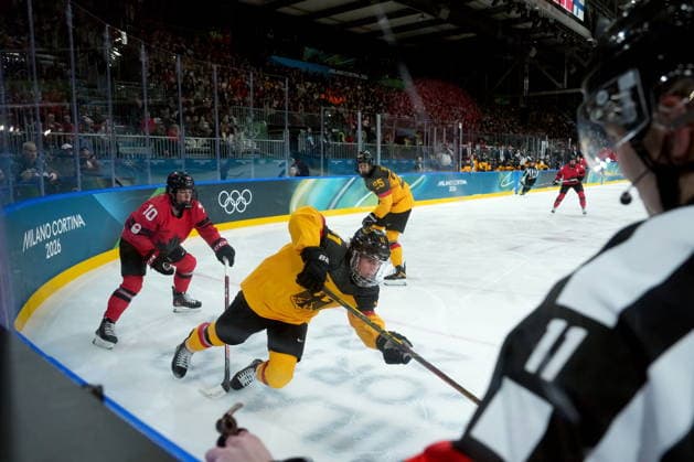 February 14, 2026, Milan, ITALY: Canada s Sarah Fillier (10) trips Germany s Nicola Hadraschek (11) during the third period of a women s hockey quarterfinal game at the 2026 Winter Olympics, in Milan, Saturday, Feb. 14, 2026. Fillier was served a tripping penalty on the play. Canada News - February 14, 2026  - ZUMAc35_ 20260214_zaf_c35_065 Copyright: xDarrylxDyckx
