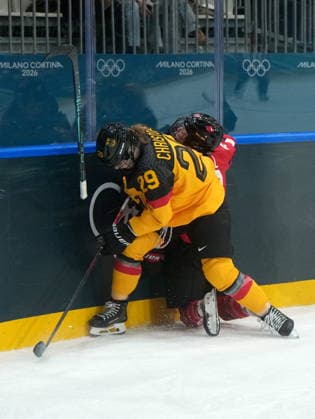 February 14, 2026, Milan, ITALY: Canada s Kristin O Neill (43) loses her stick as she s checked by Germany s Nina Christof (29) during the third period of a women s hockey quarterfinal game at the 2026 Winter Olympics, in Milan, Saturday, Feb. 14, 2026. Canada News - February 14, 2026  - ZUMAc35_ 20260214_zaf_c35_077 Copyright: xDarrylxDyckx