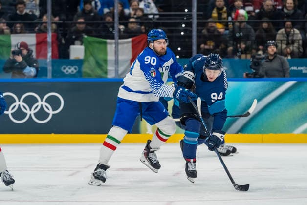 February 14, 2026, Milan, Lombardy, Italy: Defender Dylan Di Perna 90 of Team Italy and Forward Joel Kiviranta 94 of Team Finland fight for the puck during the Team Finland against Team Italy in the Preliminary Round Group B at the Milano Santagiulia Ice hockey, Eishockey Arena in MILAN, Italy during the 2026 Milano Cortina Winter Olympics. Team Finland defeats Team Italy, 11:0. Milan Italy - ZUMAa161 20260214_oly_a161_059 Copyright: xWalterxG.xArcex
