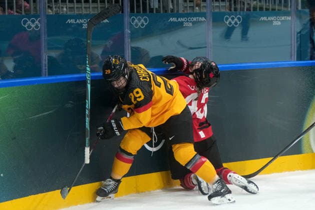 February 14, 2026, Milan, ITALY: Canada s Kristin O Neill (43) loses her stick as she s checked by Germany s Nina Christof (29) during the third period of a women s hockey quarterfinal game at the 2026 Winter Olympics, in Milan, Saturday, Feb. 14, 2026. Canada News - February 14, 2026  - ZUMAc35_ 20260214_zaf_c35_078 Copyright: xDarrylxDyckx