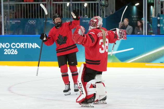 February 14, 2026, Milan, ITALY: Canada s Kati Tabin (4) and teammate Emerance Maschmeyer (38) celebrate the team s 5-1 win over Germany following the third period of a women s hockey quarterfinal game at the 2026 Winter Olympics, in Milan, Saturday, Feb. 14, 2026. Canada News - February 14, 2026  - ZUMAc35_ 20260214_zaf_c35_079 Copyright: xDarrylxDyckx