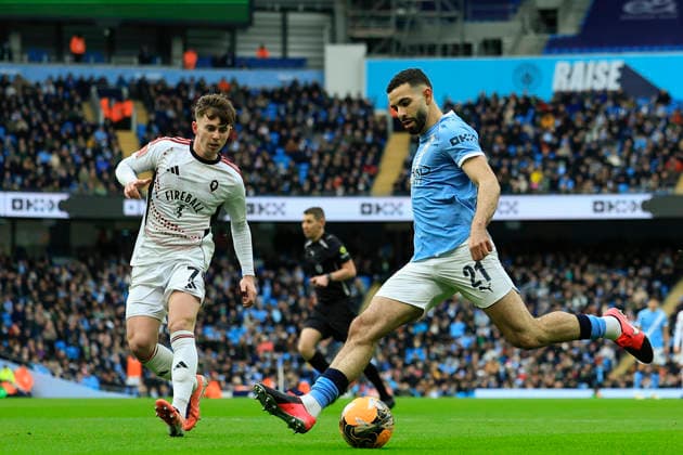 Manchester City v Salford City, FA Cup Rayan Ait-Nouri (21) of Manchester City crosses the ball watched by Ben Woodburn (7) of Salford City during the FA Cup match between Manchester City and Salford City at the Etihad Stadium, Manchester, UK on 14 February 2026. Manchester Etihad Stadium Manchester UK Editorial use only DataCo restrictions apply See www.football-dataco.com , Copyright: xConorxMolloyx PSI-23752-0094